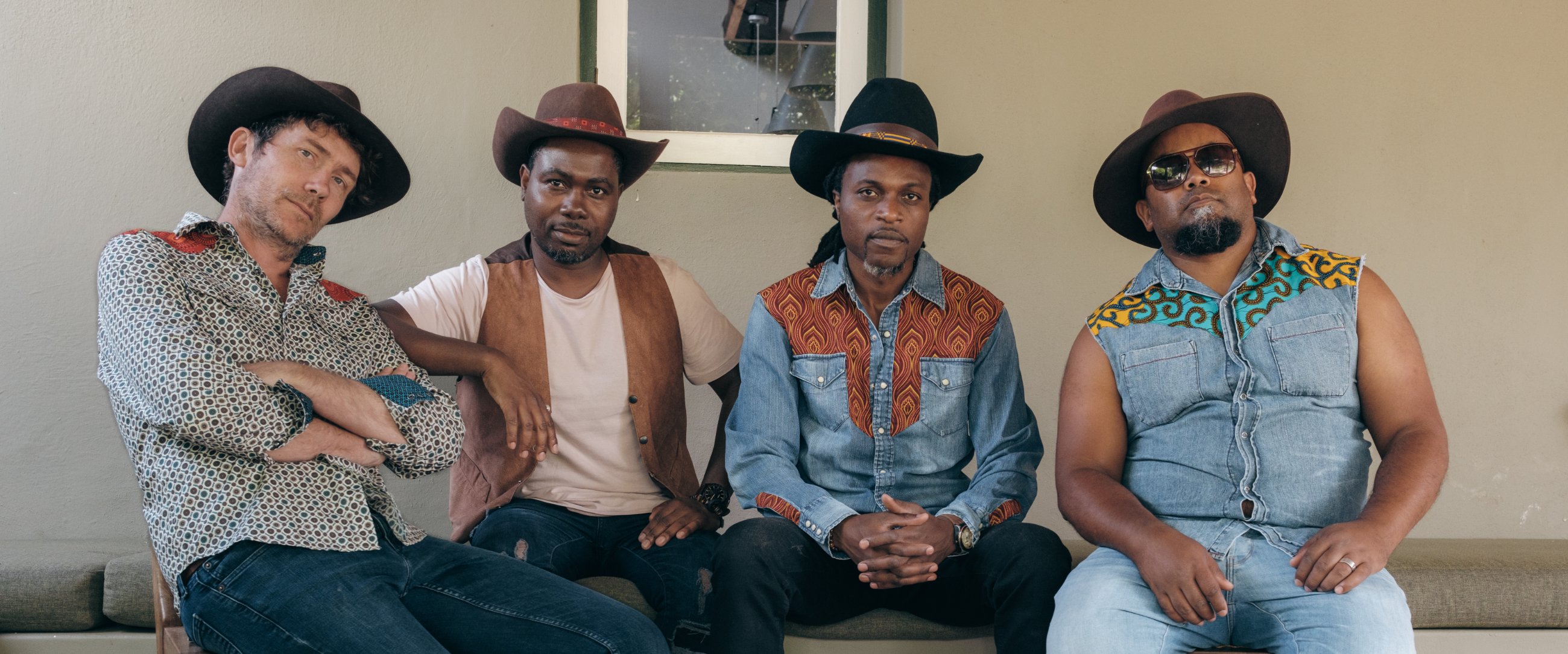 The Congo Cowboys, four members in cowboy hats and African wax-print western shirts